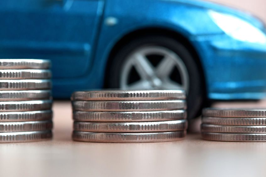 Large coins in front of car