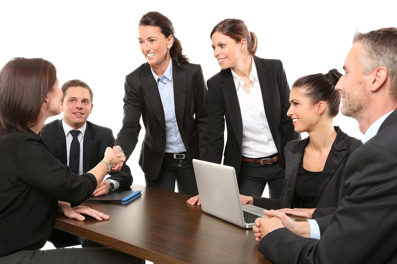 Woman shaking hands at conference table