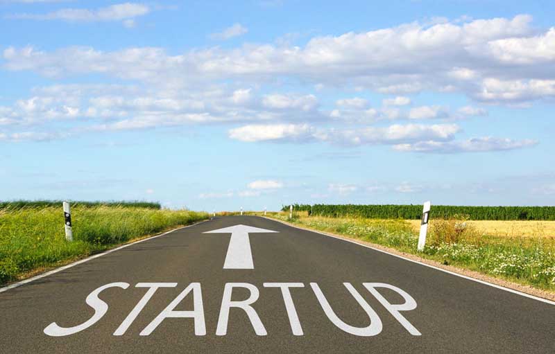 Road with the word startup and an arrow