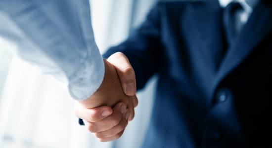 men shaking hands in business setting