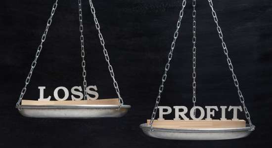 Image of two scales depicting the importance of profit margin. One scale has the word "loss" and the other has the word "profit."