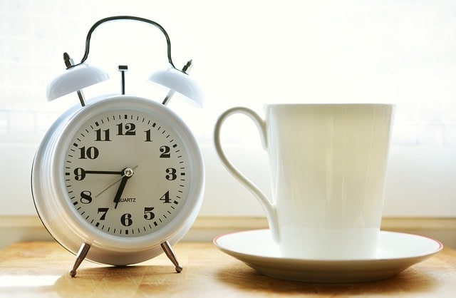A Clock and A mog on the table - Time Tracking for Project Managers -Timesheets