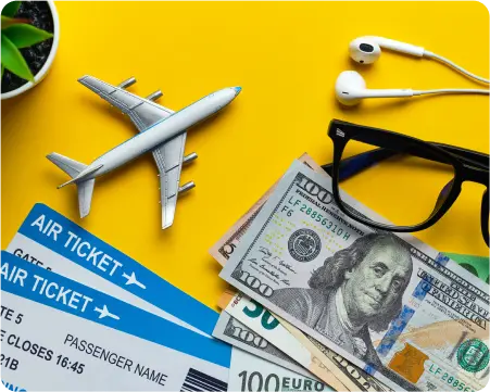 Airplane ticket, earphones, and cash arranged on a vibrant yellow background, symbolizing travel and leisure.