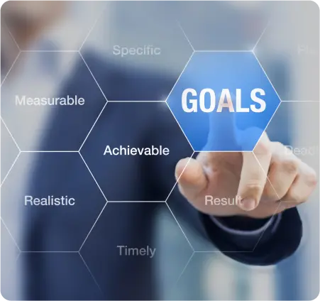 A businessman pressing the word "goals" on a digital screen, symbolizing ambition and strategic planning in business.