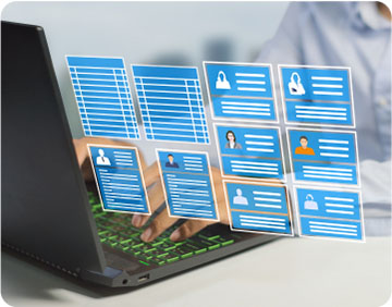 A person working on a laptop against a blue background, with various icons displayed on the screen.