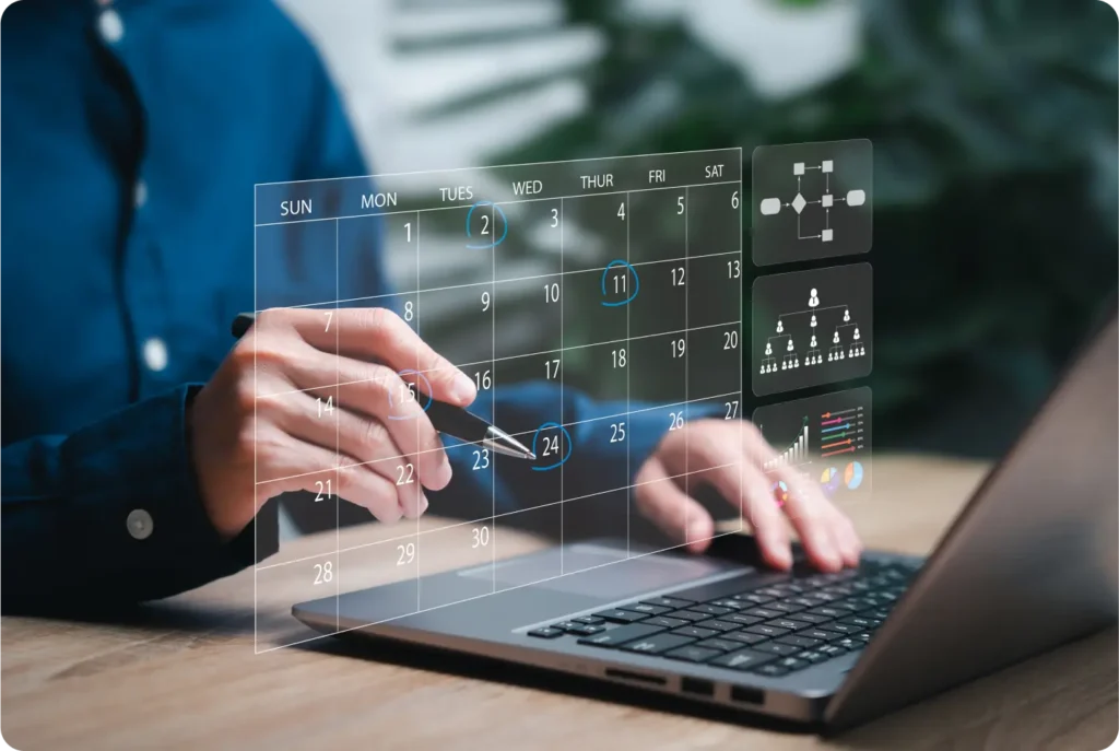 A person working on a laptop displaying a calendar, focused on planning or scheduling tasks.