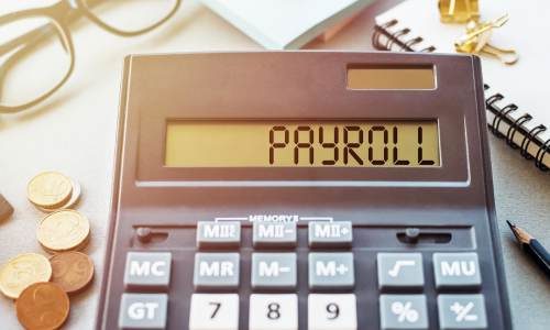 image of calculator with the word payroll spelled out